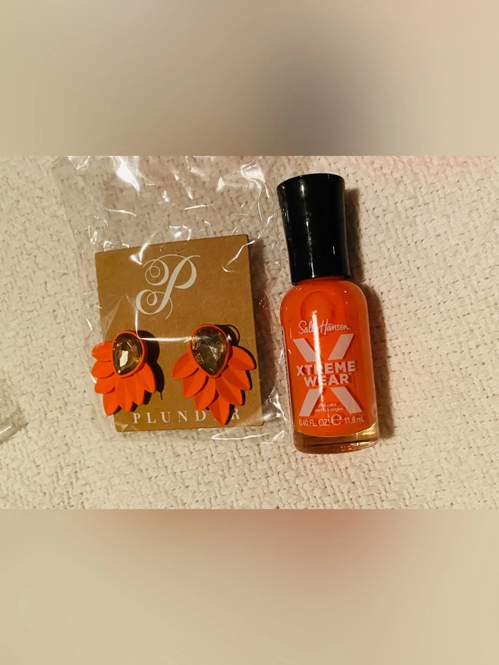 Bundle of Maybelline makeup assortment of earrings, skin care, nail polish